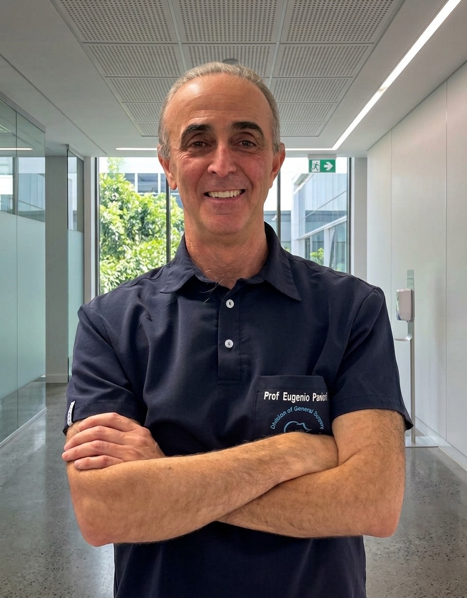 Prof Eugenio Panieri, smiling, in navy surgical scrubs